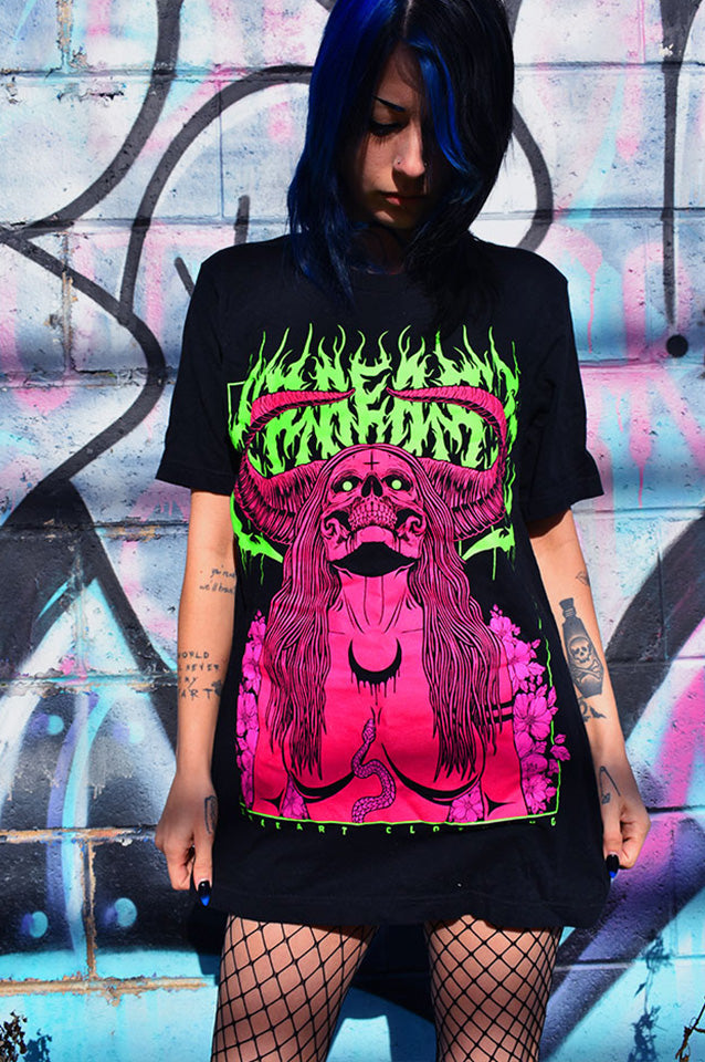 
                  
                    Succubus Witch demon in neon green, hot pink, magenta on black t-shirt with flowers and horns. Tattoo inspired Dark art tee for Mental Health by Xraeart Clothing alternative streetwear.
                  
                